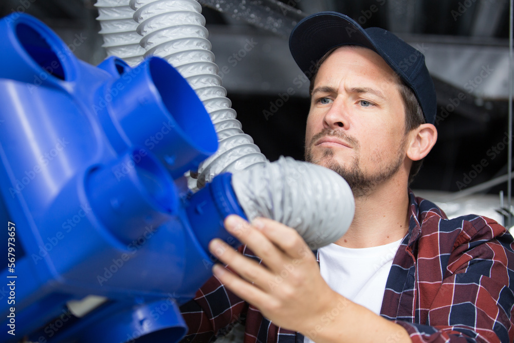 man solving a ventilation problem issue man solving a ventilation problem issue