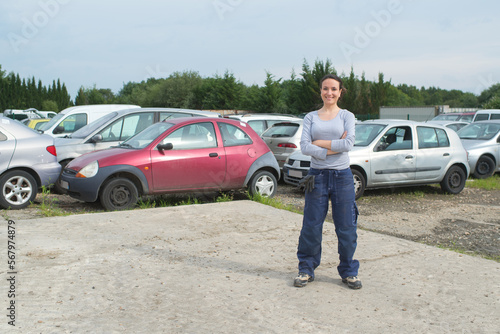 portrait of woman in vehicle scrapyard