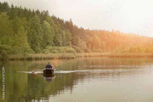 Father and son traveling in boat on lake, Bavaria, Germany photo