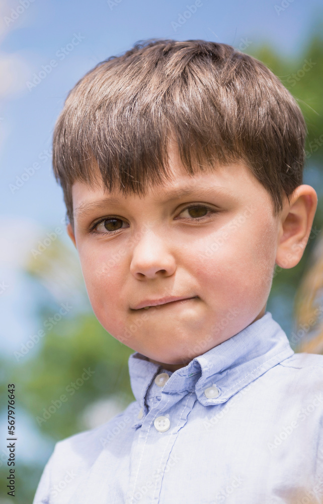 Portrait of a little boy biting his lips, Bavaria, Germany Portrait of a little boy biting his lips, Bavaria, Germany