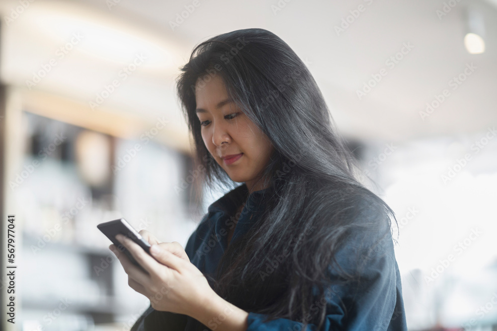 Young woman text messaging on mobile phone, Freiburg im Breisgau, Baden-Württemberg, Germany Young woman text messaging on mobile phone, Freiburg im Breisgau, Baden-Württemberg, Germany