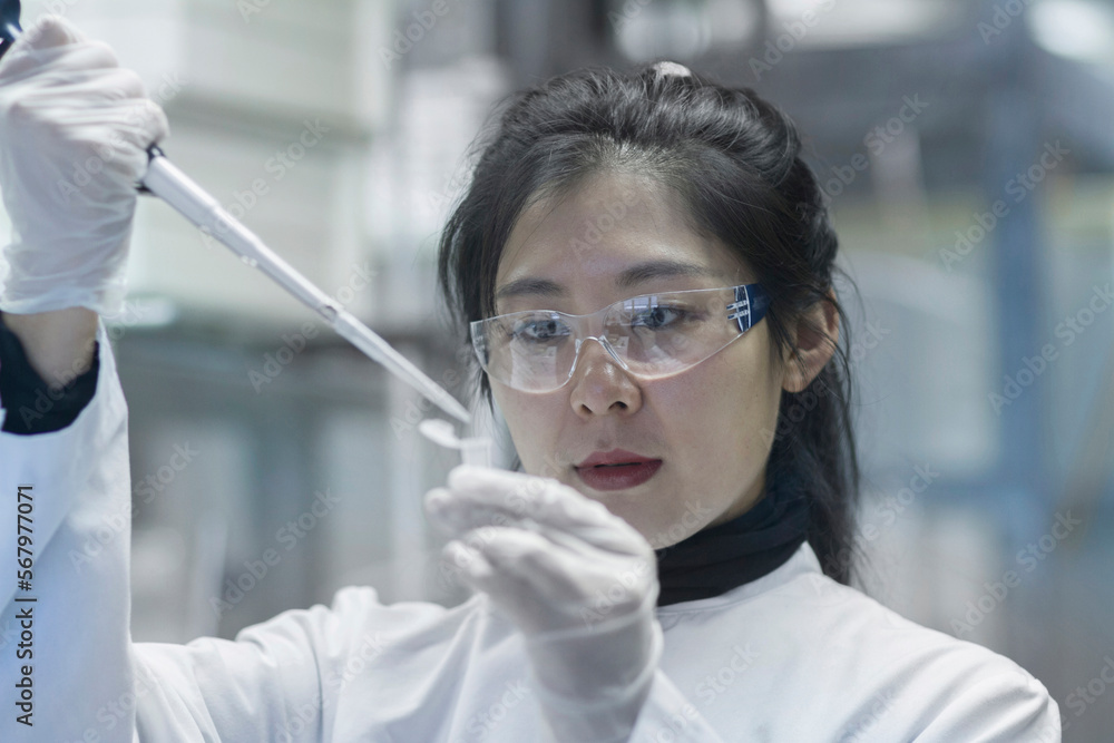 Young female scientist working in a laboratory, Freiburg im Breisgau, Baden-Württemberg, Germany Young female scientist working in a laboratory, Freiburg im Breisgau, Baden-Württemberg, Germany
