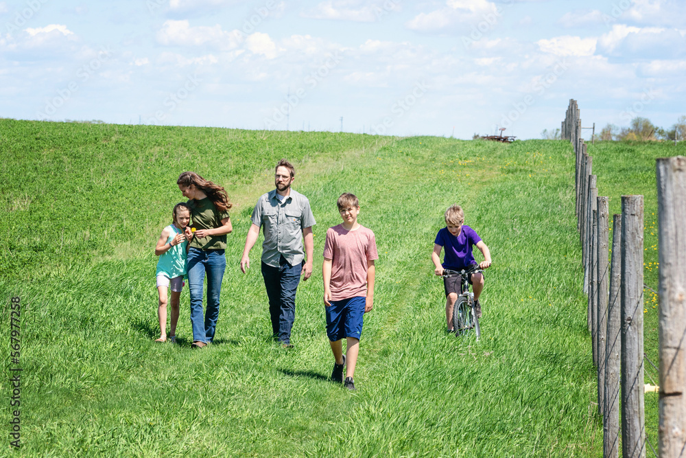 Family of five walking in a field in the country. Family of five walking in a field in the country.