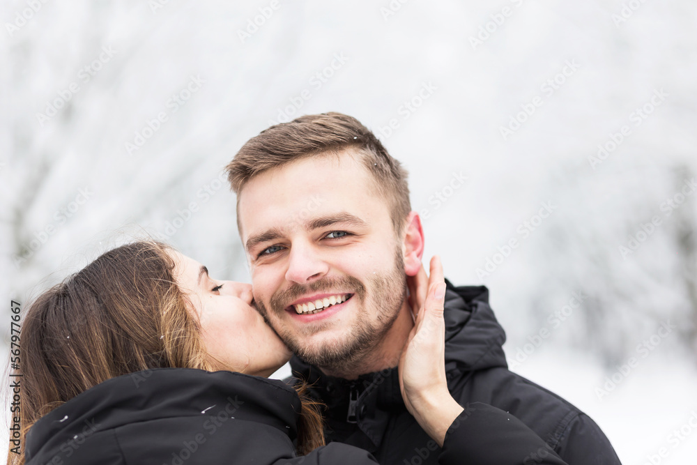 Guy and girl hugging themselves in the snowy winter park Guy and girl hugging themselves in the snowy winter park