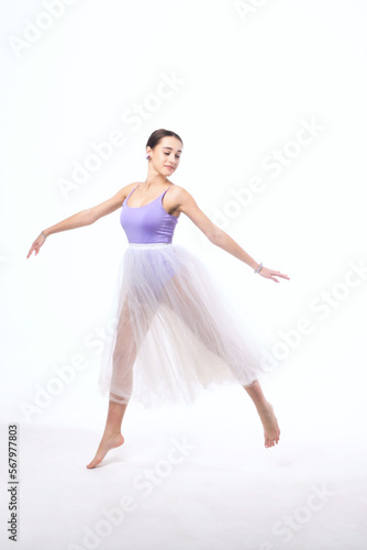 Young woman in a tulle skirt posing on a white background.