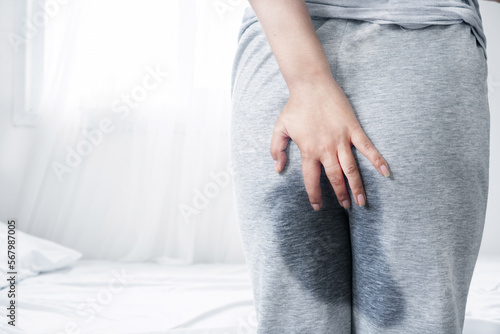 old woman peeing in her pant after waking up in the morning, Stress Urinary incontinence concept photo