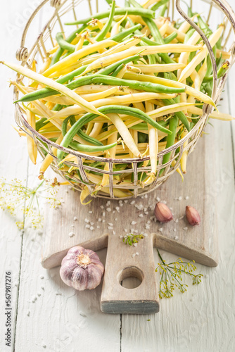 Ingredients for pickled yellow and green beans in basket.