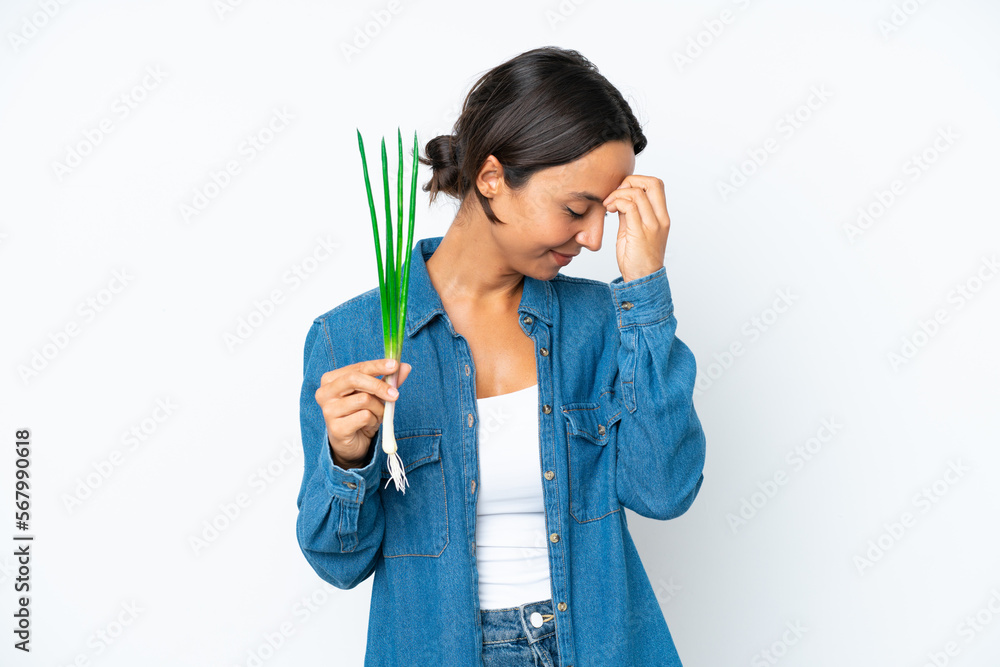 Young hispanic woman holding chive isolated on white background laughing Young hispanic woman holding chive isolated on white background laughing