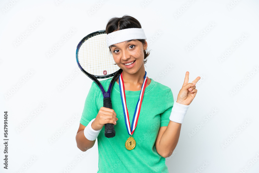 Young tennis player woman isolated on white background smiling and showing victory sign Young tennis player woman isolated on white background smiling and showing victory sign