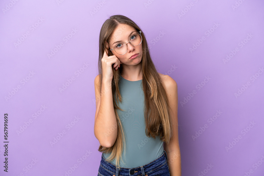 Young Lithuanian woman isolated on purple background thinking an idea Young Lithuanian woman isolated on purple background thinking an idea