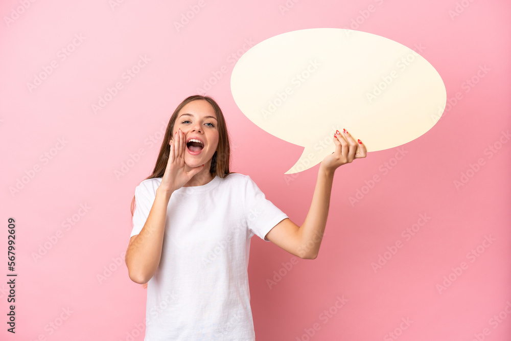 Young Lithuanian woman isolated on pink background holding an empty speech bubble and shouting Young Lithuanian woman isolated on pink background holding an empty speech bubble and shouting