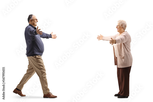 Full length profile shot of a happy mature man meeting an older woman