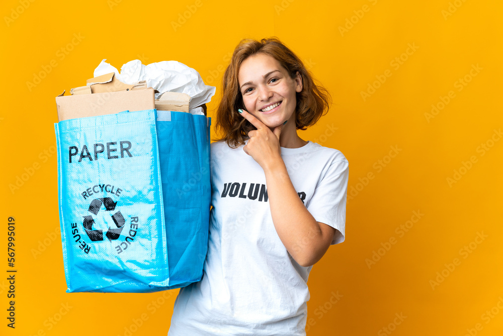 Young Georgian girl holding a recycling bag full of paper to recycle happy and smiling Young Georgian girl holding a recycling bag full of paper to recycle happy and smiling