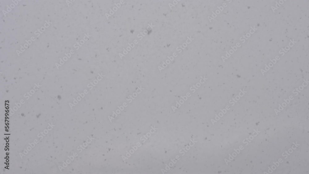 Slow motion snow falling over white clouds Slow motion snow falling over white clouds