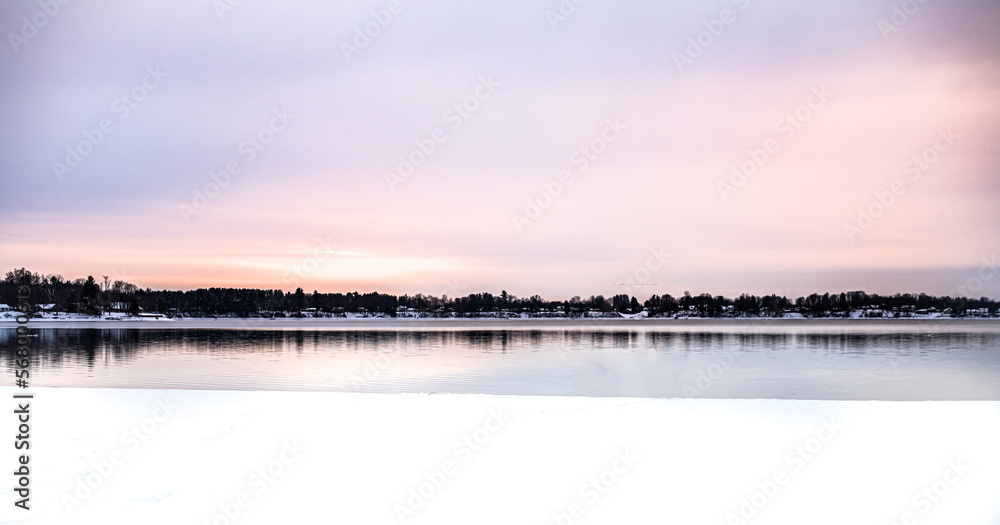 Pink sunset over a lake in winter