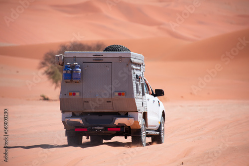 4x4 suv vehicle rides through the sand dune Namib desert - Namibia photo