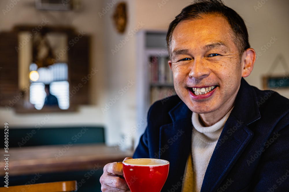Middle-aged Asian man drinking coffee alone in the cafeteria. Middle-aged Asian man drinking coffee alone in the cafeteria.