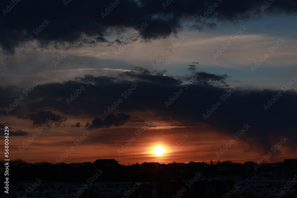 A beautiful sunset with clouds above the village. A beautiful sunset with clouds above the village.