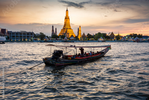 Wat Arun and boats,at sunset,along the Chao Phraya river,Bangkok,Thailand. © Neil