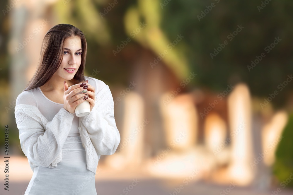 Fototapeta premium Happy young woman in casual clothes posing with coffee cup