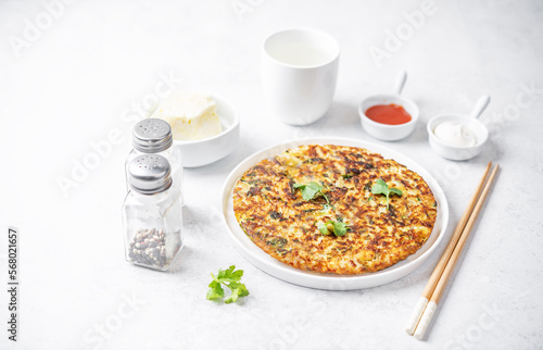 Cabbage omelet with cilantro leaves in a plate