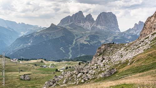 View of Sassolungo and Sassopiatto mountain massifs as seen from trail #601 (Alta Via 2 trail) descending to Pordoi Pass from Baita Fedarola refuge, Dolomites, South Tyrol, Italy