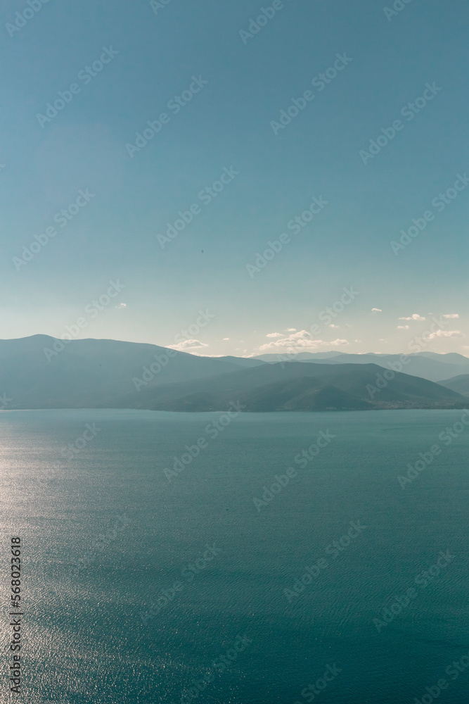 sea and mountains in sun
