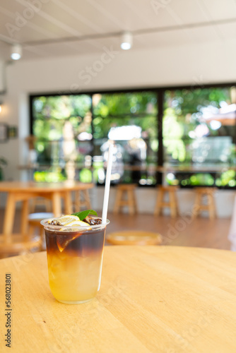 lemon with black coffee in glass