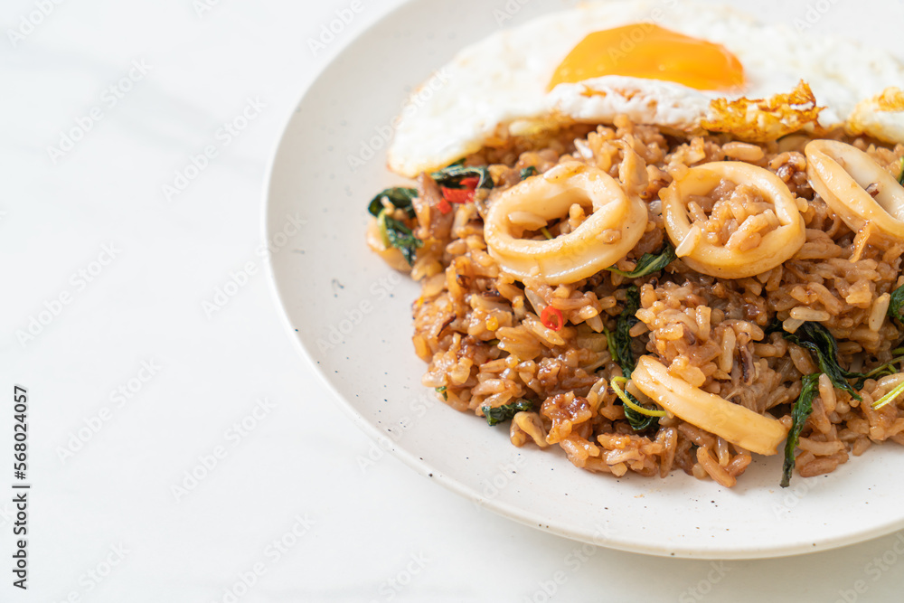 fried rice with squid and basil topped fried egg in Thai style fried rice with squid and basil topped fried egg in Thai style