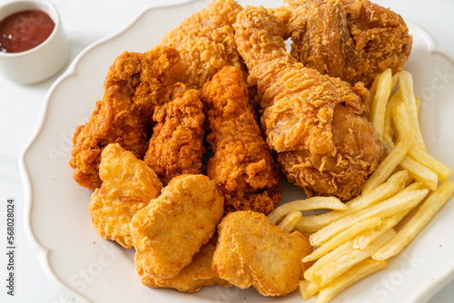 fried chicken with french fries and nuggets on plate