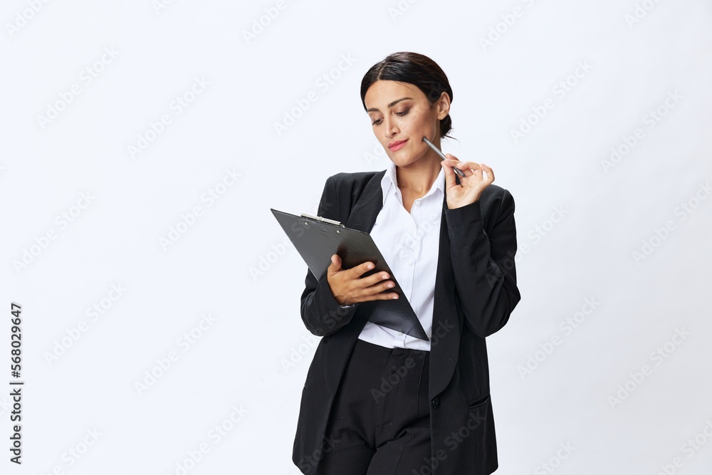 Business woman folder with documents in black business suit shows signals gestures and emotions on white background, freelancer job online time management Business woman folder with documents in black business suit shows signals gestures and emotions on white background, freelancer job online time management