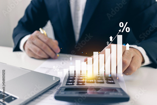 Revenue graph growth rate increase concept.Businessman calculating income and return on investment on document management.financial, taxes, analysis, planning to long-term growth with icon.
