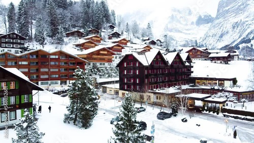 Grindelwald village in Switzerland aerial drone video on snowy day in winter time
