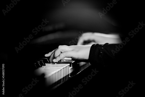 Pianist male hands playing music on piano keys. photo