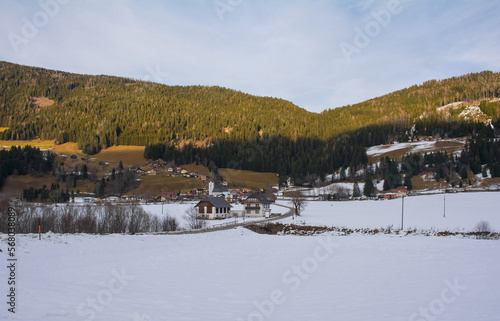 The snowy winter landscape near Sankt Margarethen in the Sankt Paul im Lavanttal municipality of the Wolfsberg District, Carinthia, Austria. The parish church of Sankt Margarethen is seen in the centr