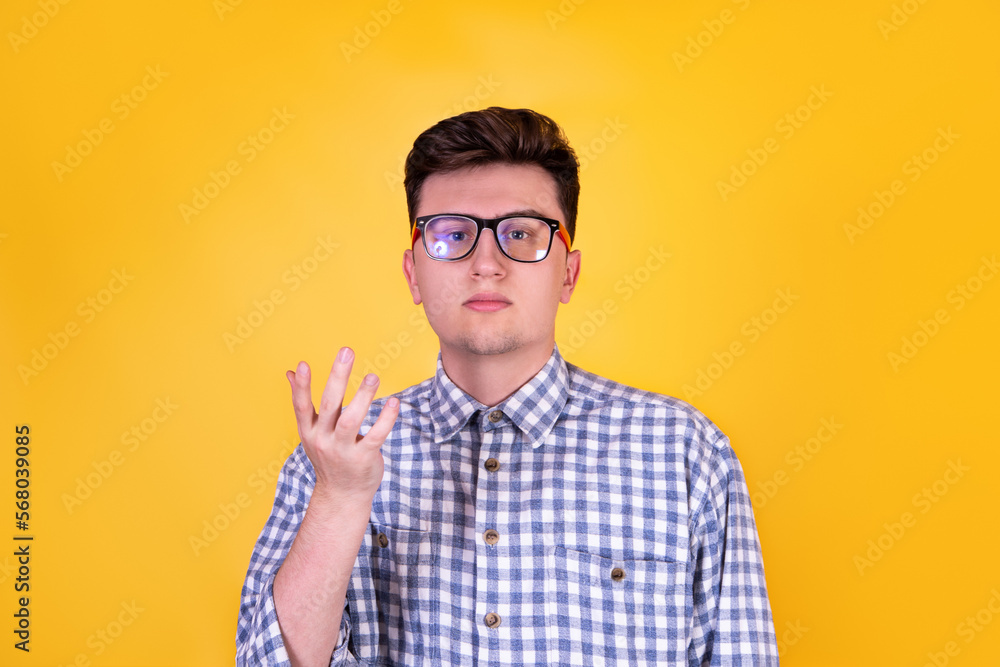 A handsome guy in glasses on a yellow background A handsome guy in glasses on a yellow background