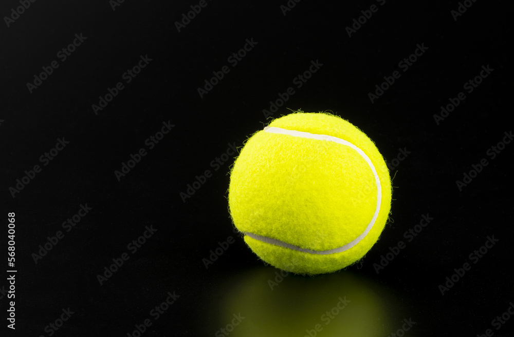 tennis ball on black background with copy space
