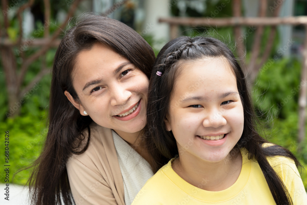 Portrait of happy smiling Asian mother and daughter
