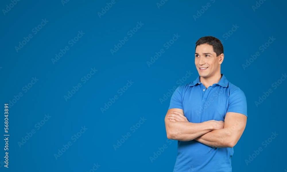 Smiling young man posing on background Smiling young man posing on background