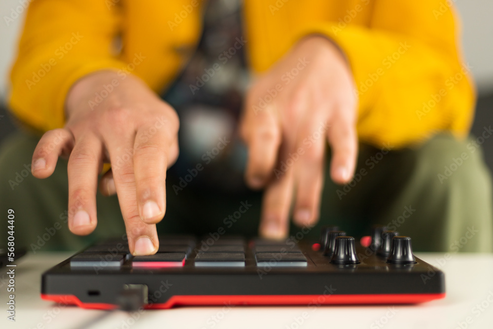 The hands of a man making beats on his MPD MIDI controller The hands of a man making beats on his MPD MIDI controller