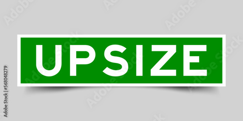 Green color square shape sticker label with word upsize on gray background