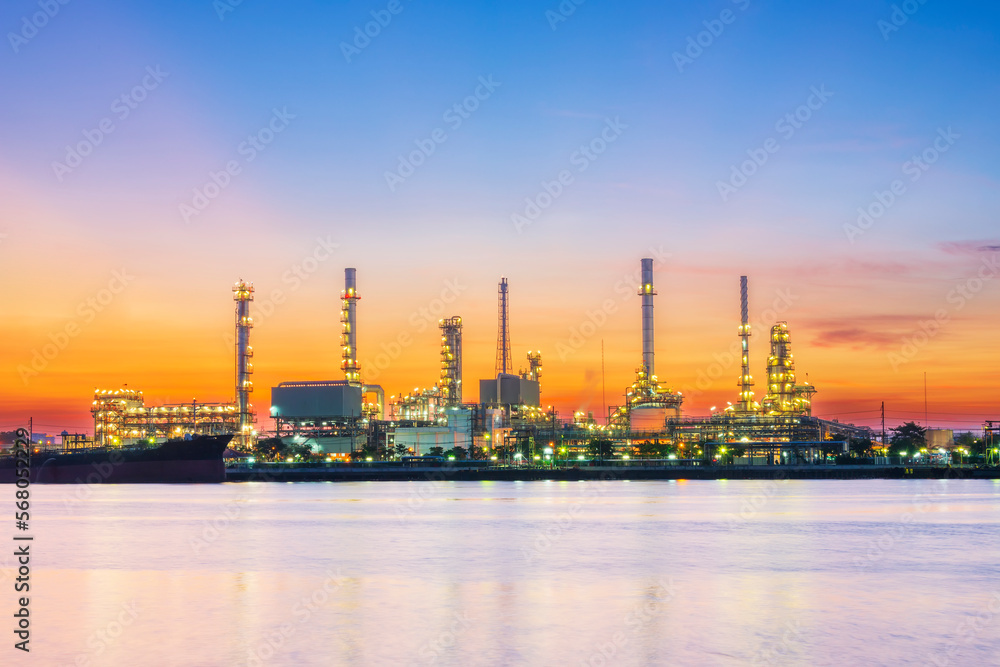 Panorama of oil refinery with reflection, petrochemical plant.Gas refinery beside river.Colorful twilight at sunrise time.Slow speed shutter made motion blur.Water pollution from industry may concern.