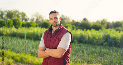 Portrait, sustainability and farmer man working outdoor on grass field or land. Arms crossed, agriculture or profesional farming male, worker or business owner from usa, career in the farm industry