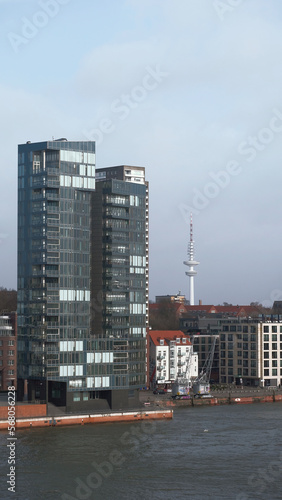 Hamburg, Germany - 02 02 2022: View from the ship on the luxury skyscraper with modern apartments in Hamburg harbor with a mast on the background