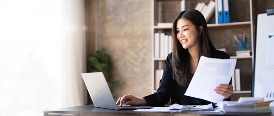 Business woman using calculator for do math finance on wooden desk in office and business working background, tax, accounting, statistics and analytic research concept.
