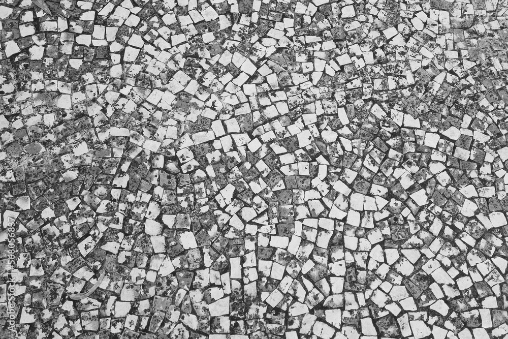 Black and white photo. Texture of paving slabs. The background of the stone. Black and white photo. Texture of paving slabs. The background of the stone.
