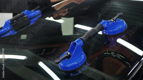 Glass of the car is a close-up in the room, removed with the help of professional suction cups. The process of car repair