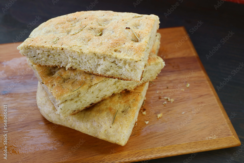 Stack of Rosemary Focaccia Bread Slices on Wooden Breadboard