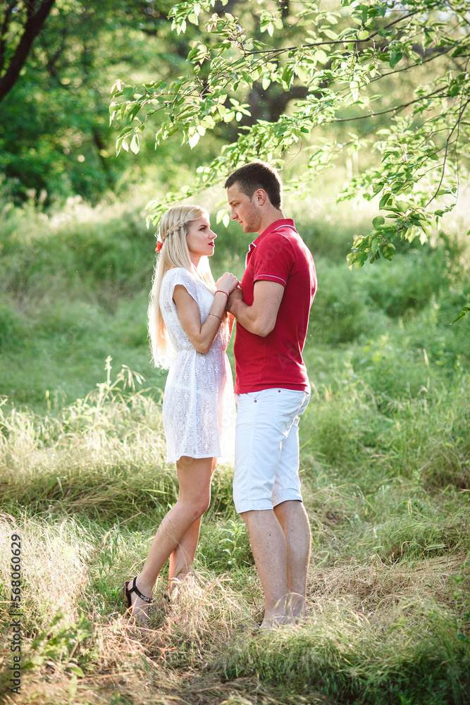 couple in love at a picnic in a park with green grass couple in love at a picnic in a park with green grass