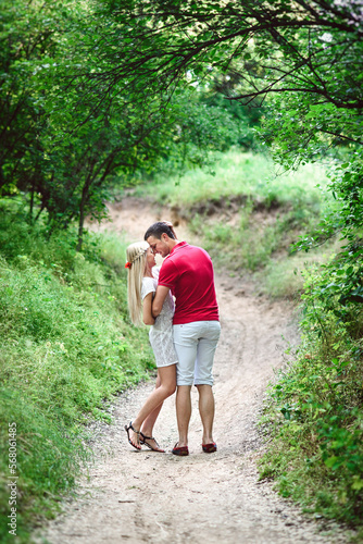 couple in love at a picnic in a park with green grass © omelnickiy